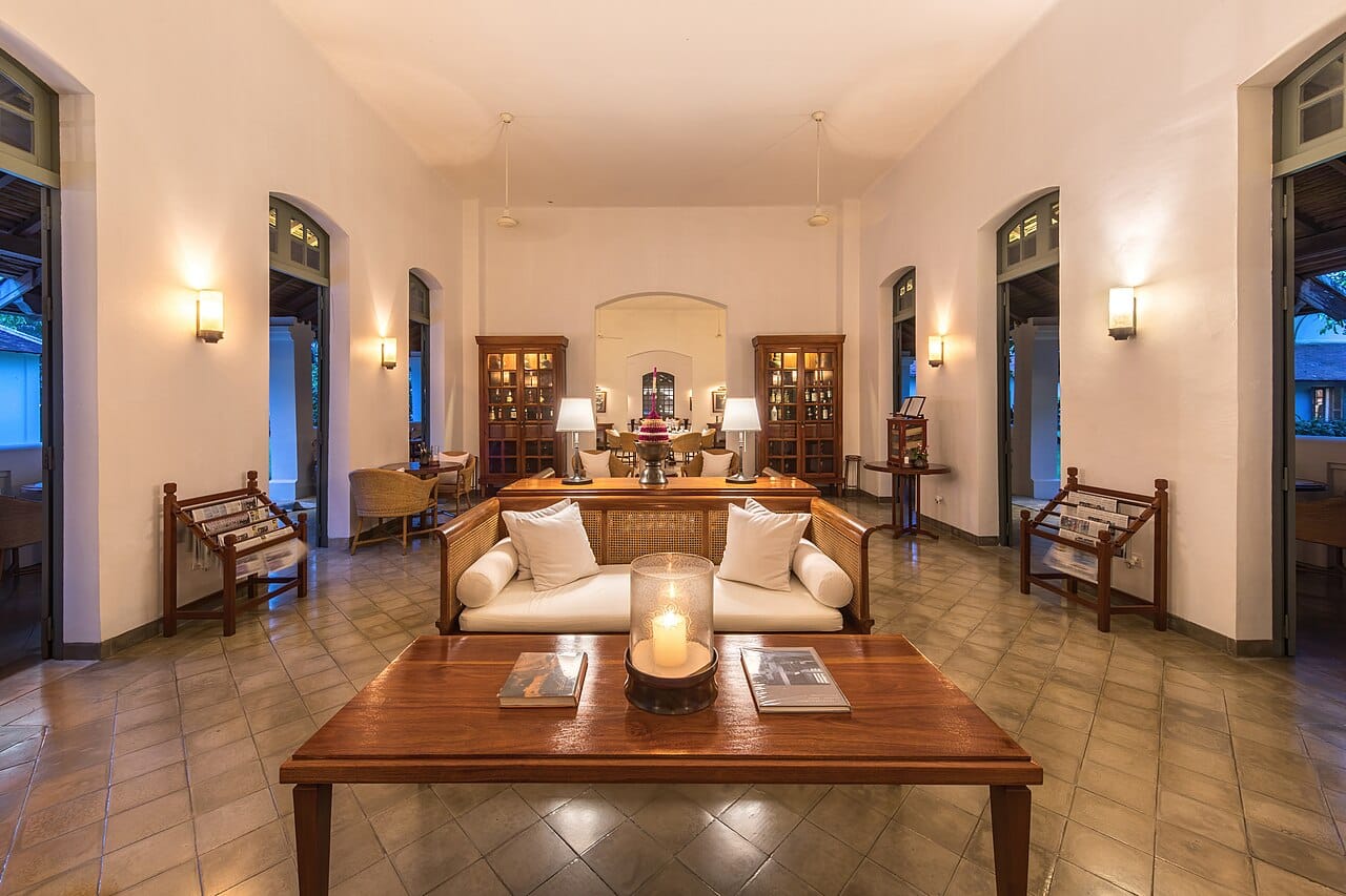 Luxurious reception lounge at Amantaka Resort in Luang Prabang, Laos — a premier Bitcoin-accepting luxury hotel with warm colonial architecture