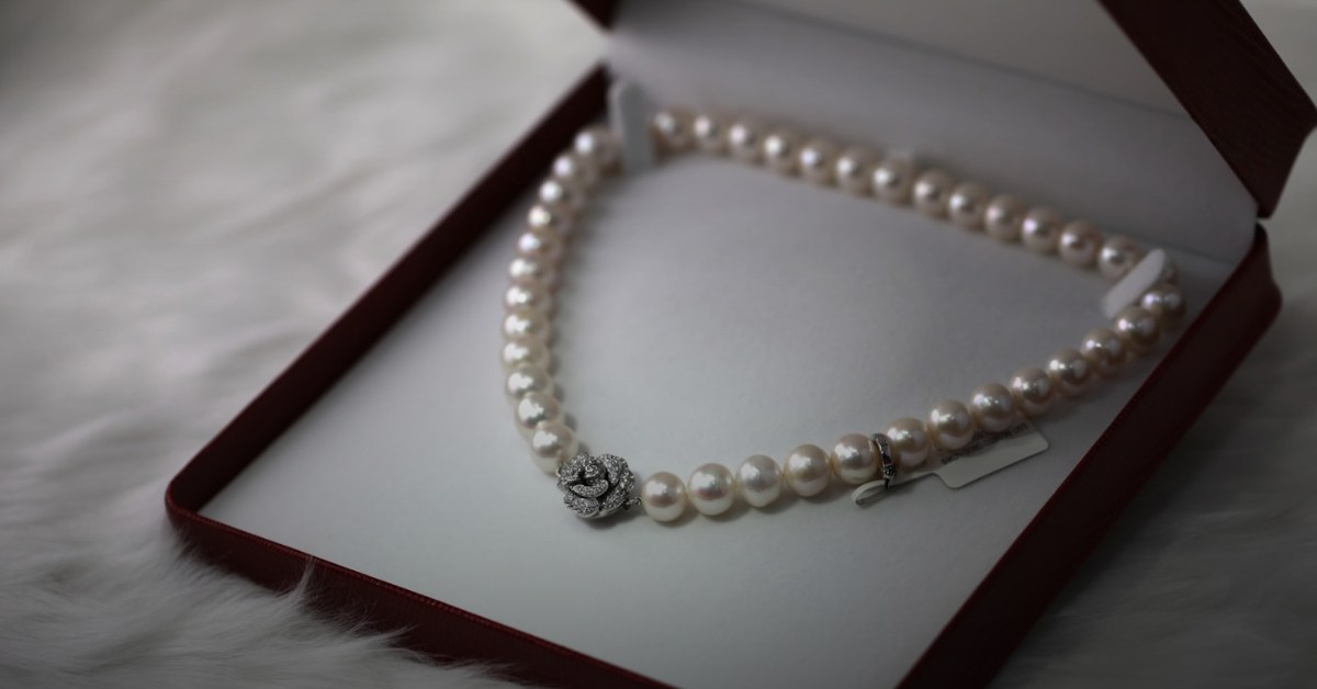 Fine gold jewelry on dark surface — buy Cartier with Bitcoin