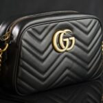 Luxury leather handbag on dark surface — buy a Hermès Birkin with Bitcoin