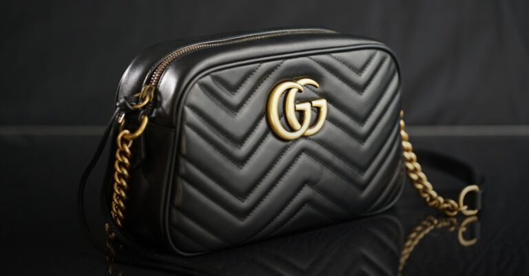 Luxury leather handbag on dark surface — buy a Hermès Birkin with Bitcoin