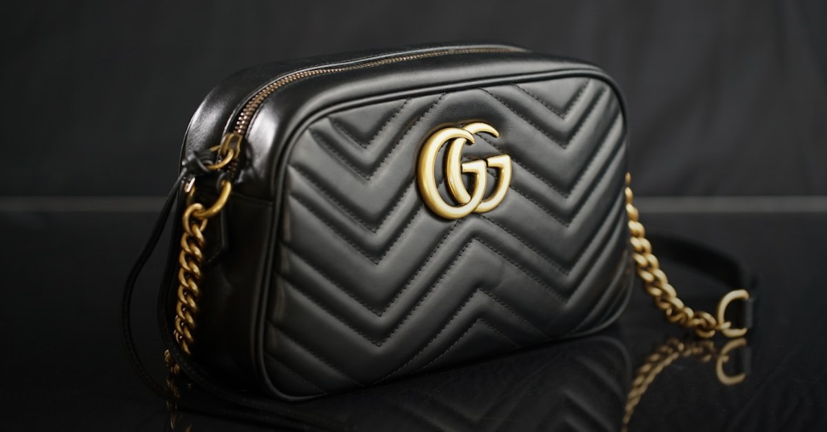 Luxury leather handbag on dark surface — buy a Hermès Birkin with Bitcoin