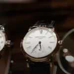 Patek Philippe dress watches on display with a horologist's loupe — Grand Complications buying guide