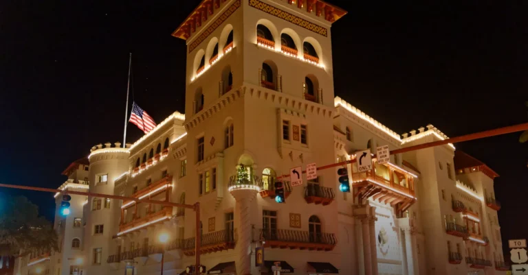 Casa Monica Resort and Spa illuminated at night in St. Augustine, a Kessler Collection hotel that accepts Bitcoin via BitPay